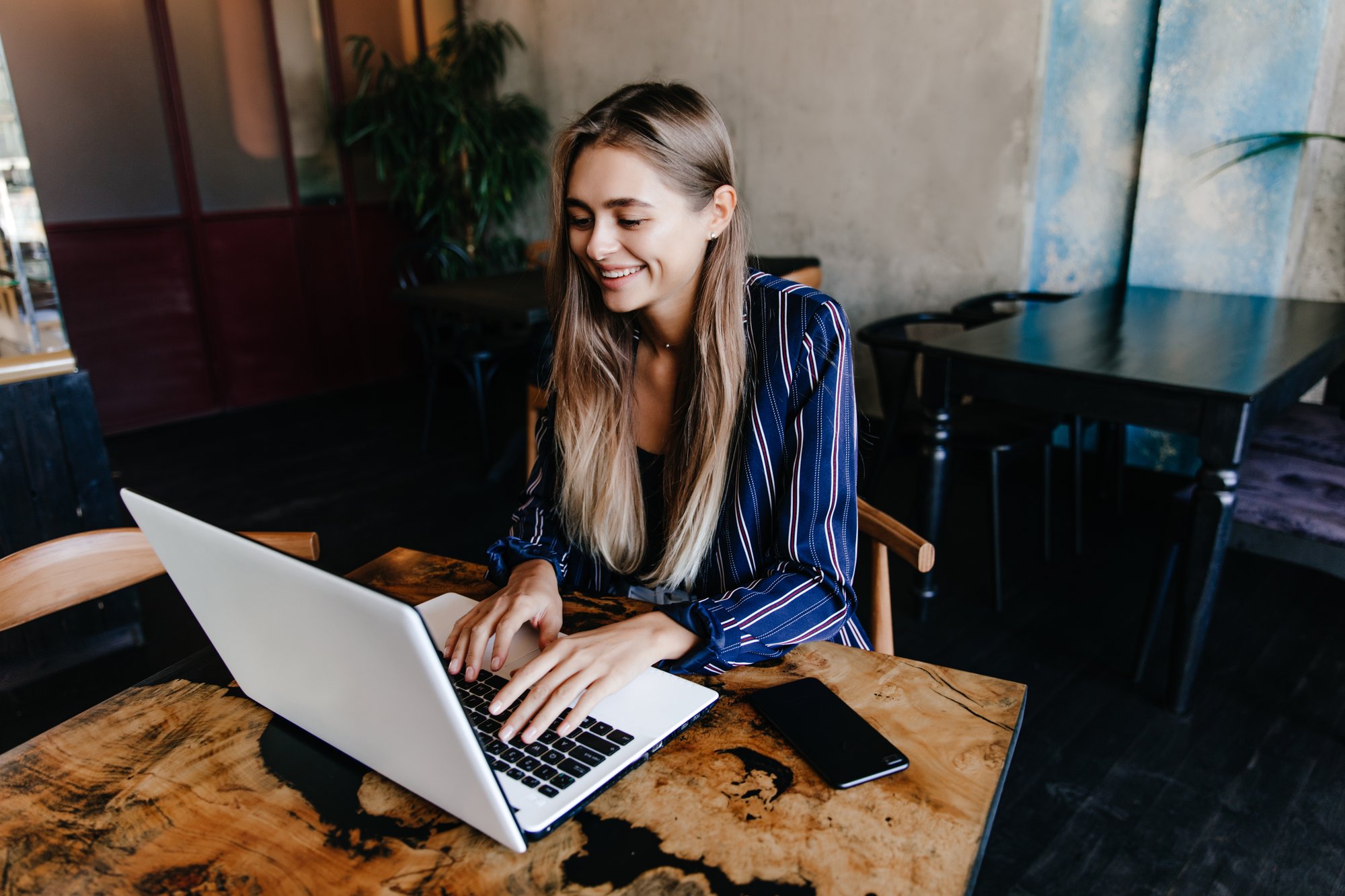 appealing-girl-typing-keyboard-with-smile-indoor-shot-beautiful-long-haired-woman-working-with-laptop-laughing