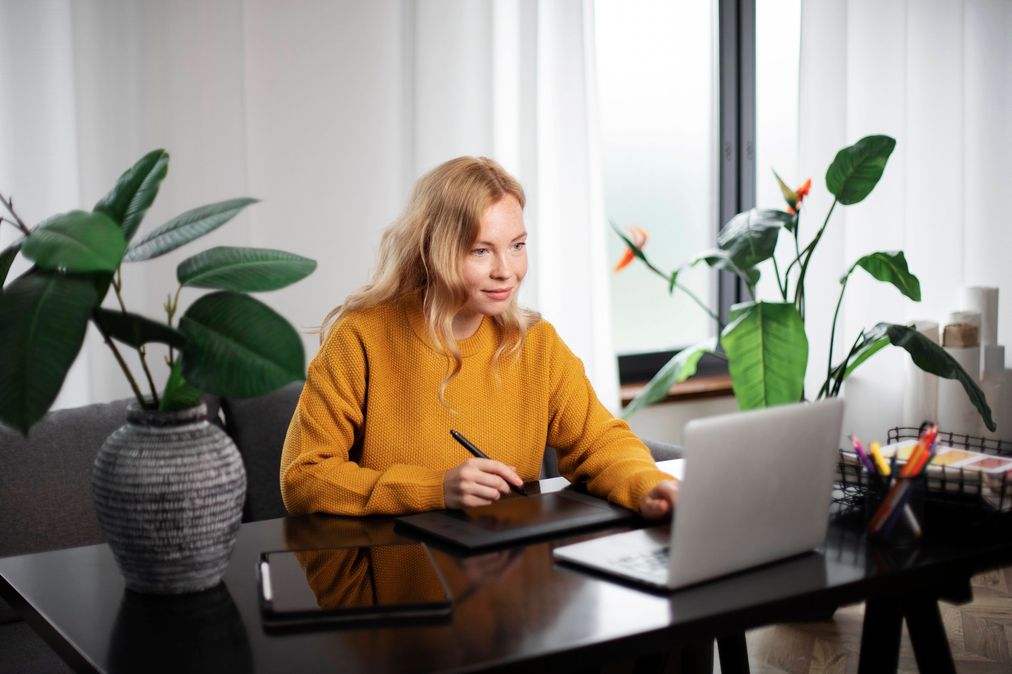 female-logo-designer-working-her-tablet-connected-laptop female-logo-designer-working-her-tablet-connected-laptop